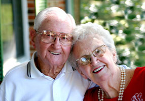 Photo of a man and woman smiling for a picture. 